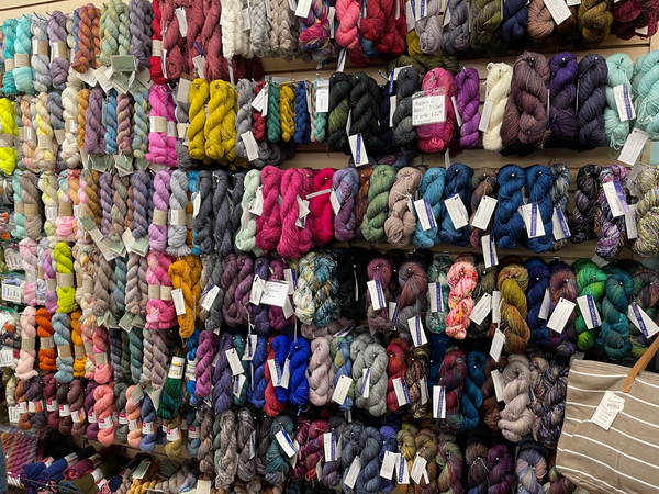 brightly colored wall full of yarn